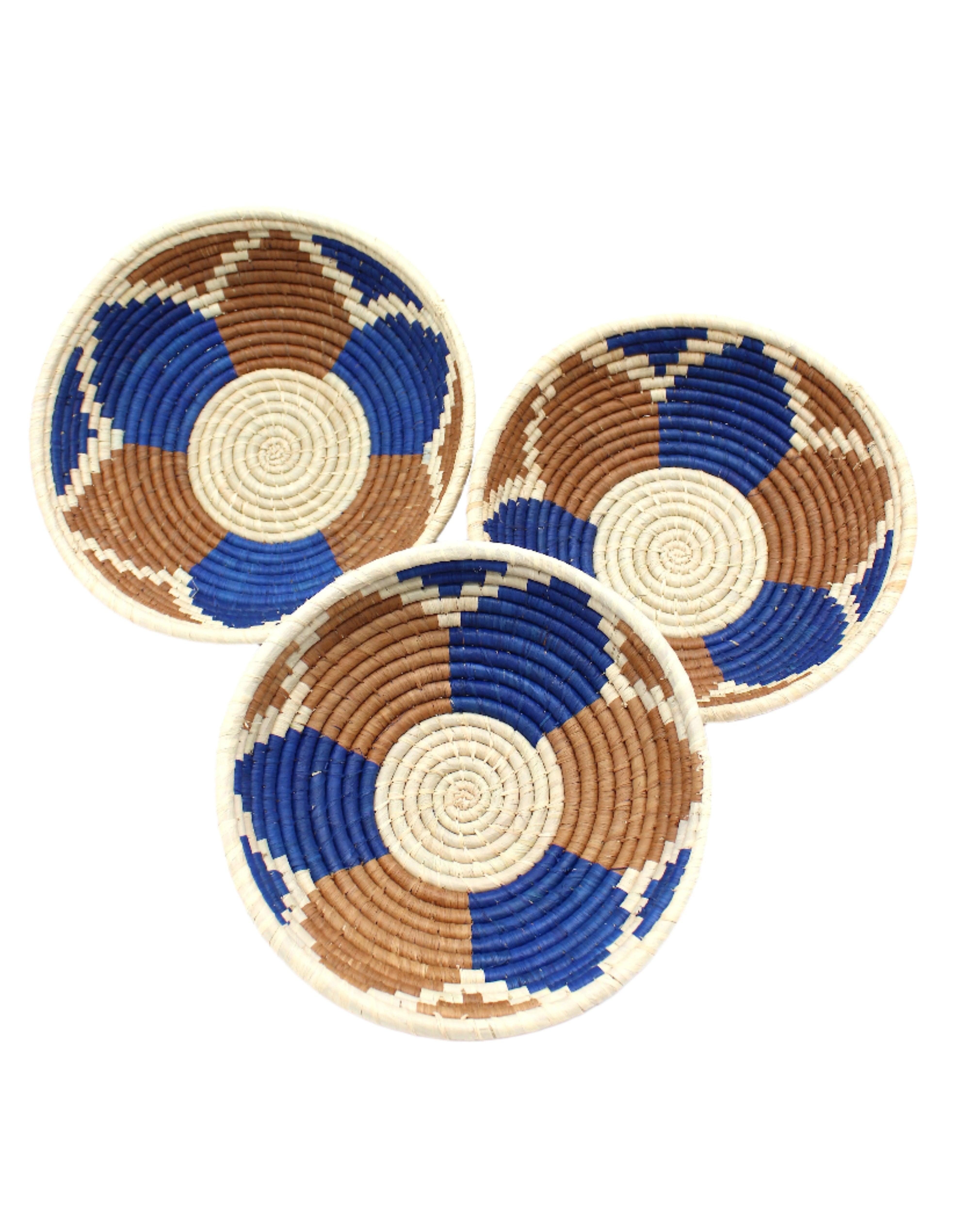 Amara Raffia Straw Decor Display Basket Bowls: Set of 3 handmade woven natural raffia palm fiber in a crochet loop technique concentric coiled circular pattern with natural straw color centered in the bottom with blue, cinnamon/tobacco/brown, and natural geometric floral design pattern up the sides of the bowls set of small, medium, and large straw display bowls - Shebobo