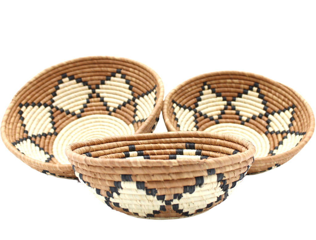 Side view Amara Raffia Straw Decor Display Basket Bowls: Set of 3 handmade woven natural raffia palm fiber in a crochet loop technique concentric coiled circular pattern with natural straw color centered in the bottom with cinnamon/tobacco/brown sides and natural diamond with black edges pattern set of small, medium, and large straw display bowls - Shebobo