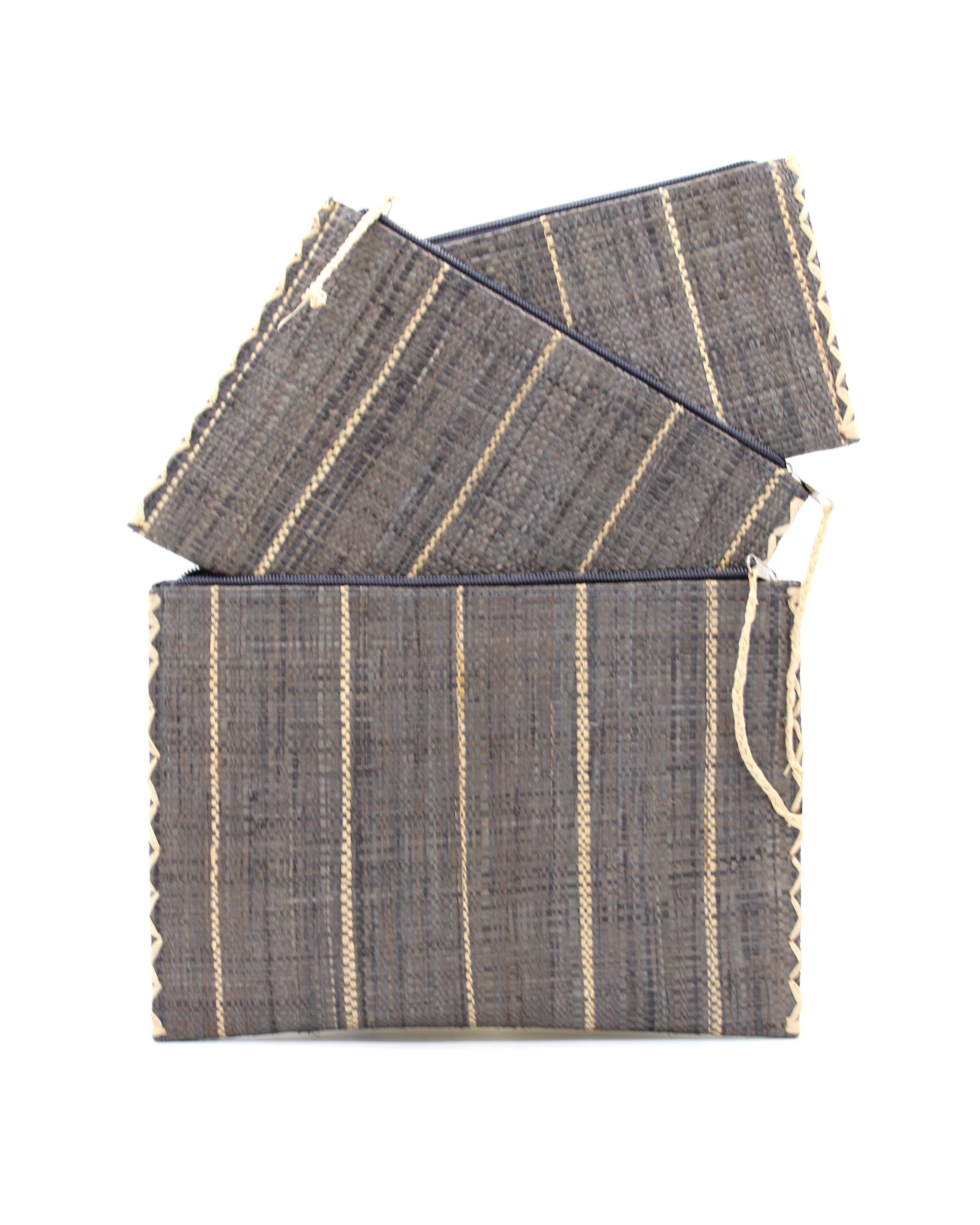 Amelia Set of 3 Grey Nesting Zippered Straw Clutches Pinstripe Pattern handmade loomed raffia in wide vertical bands of grey with narrow bands of natural straw color with matching zipper and braided zipper pull with cross stitch edging in three sizes of small, medium, and large - Shebobo