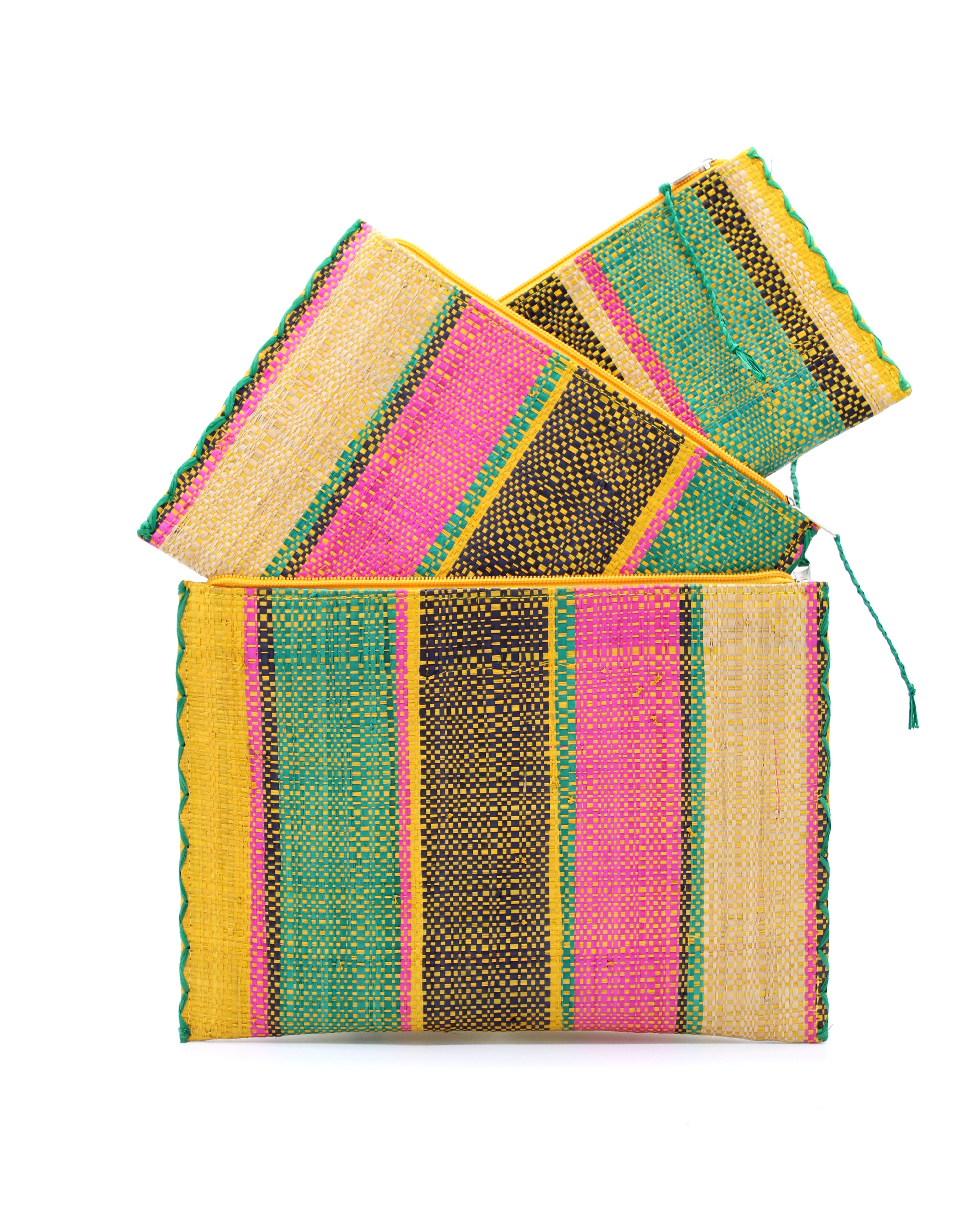 Amelia Set of 3 Nesting Zippered Straw Clutches Carmalita Multicolor Stripe Pattern handmade loomed raffia in multiple widths of vertical stripes in turquoise, black, fuchsia, and saffron with matching zipper and braided zipper pull with cross stitch edging in three sizes of small, medium, and large - Shebobo