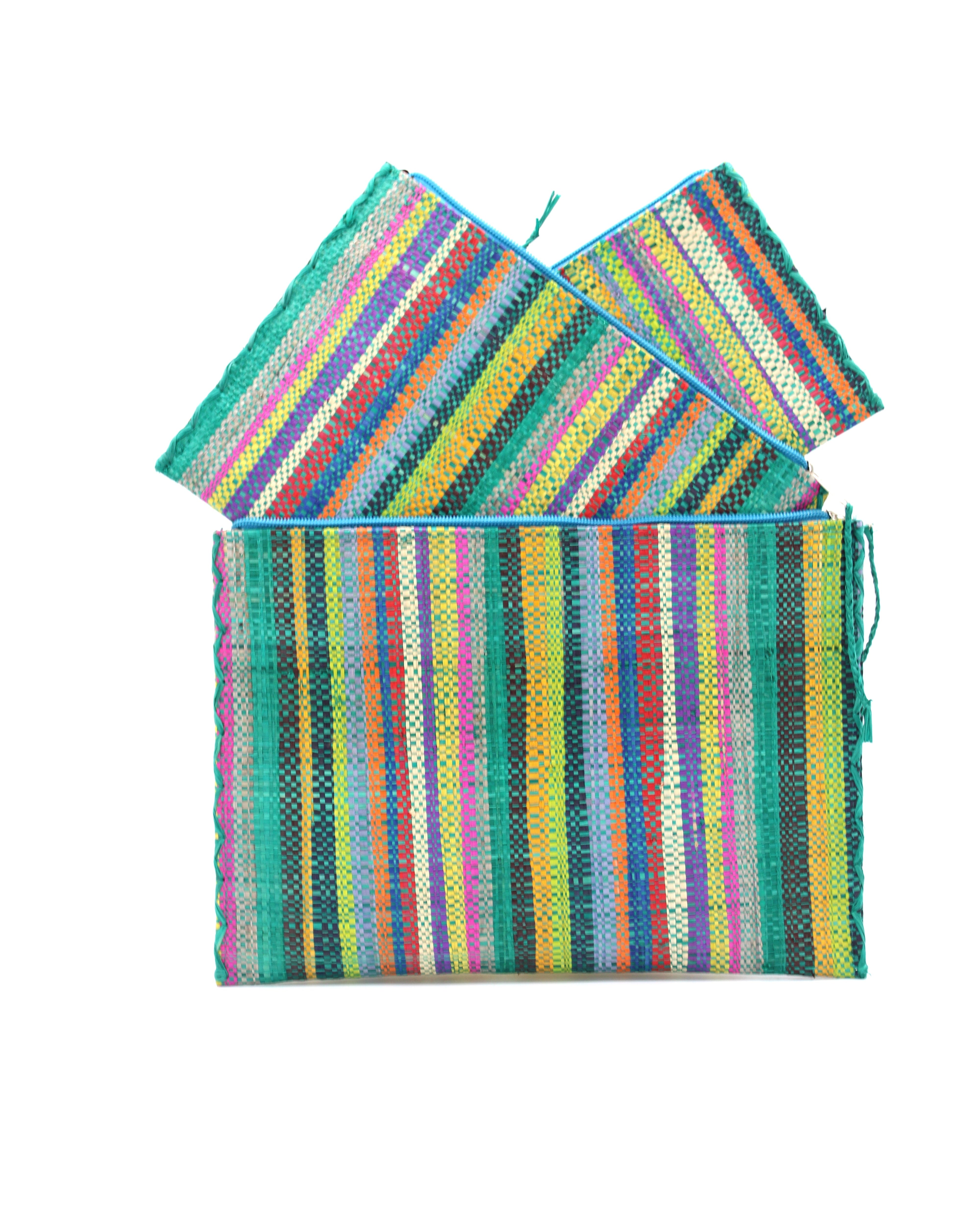 Amelia Set of 3 Nesting Zippered Straw Clutches Turquoise Stripe Multicolor Stripe Pattern handmade loomed raffia in multiple widths of vertical stripes in natural, orange, turquoise, saffron, seafoam, red, fuchsia pink, etc. with matching turquoise zipper and braided zipper pull with cross stitch edging in three sizes of small, medium, and large - Shebobo