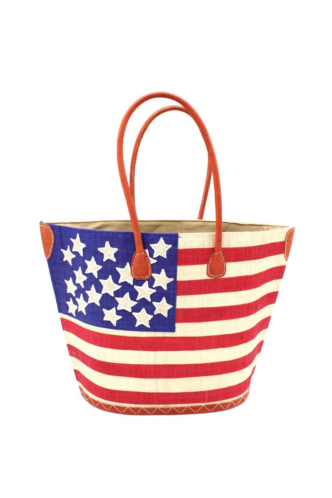 American Flag Straw Tote Bag handmade loomed raffia palm fiber in a multicolor dusk navy/dark/blue, red, and natural straw color patriotic American Flag pattern across the front of the bag with matching stitching and leather handles shoulder bag beach bag tote handbag - Shebobo