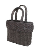 Side view Anna Petal Pattern Crochet Straw Basket Handbag handmade natural raffia palm fiber in a solid hue of Black crochet in multiple textures resulting in a subtle pattern of vertical linked bands on the bottom 2/3 of the bag, and a floral petal or shell pattern on the upper third with rolled panel of links making up the handles Beach Bag Purse - Shebobo