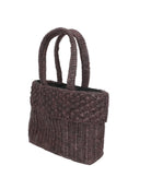 Side view Anna Petal Pattern Crochet Straw Basket Handbag handmade natural raffia palm fiber in a solid hue of Espresso chocolate/dark/brown crochet in multiple textures resulting in a subtle pattern of vertical linked bands on the bottom 2/3 of the bag, and a floral petal or shell pattern on the upper third with rolled panel of links making up the handles Beach Bag Purse - Shebobo