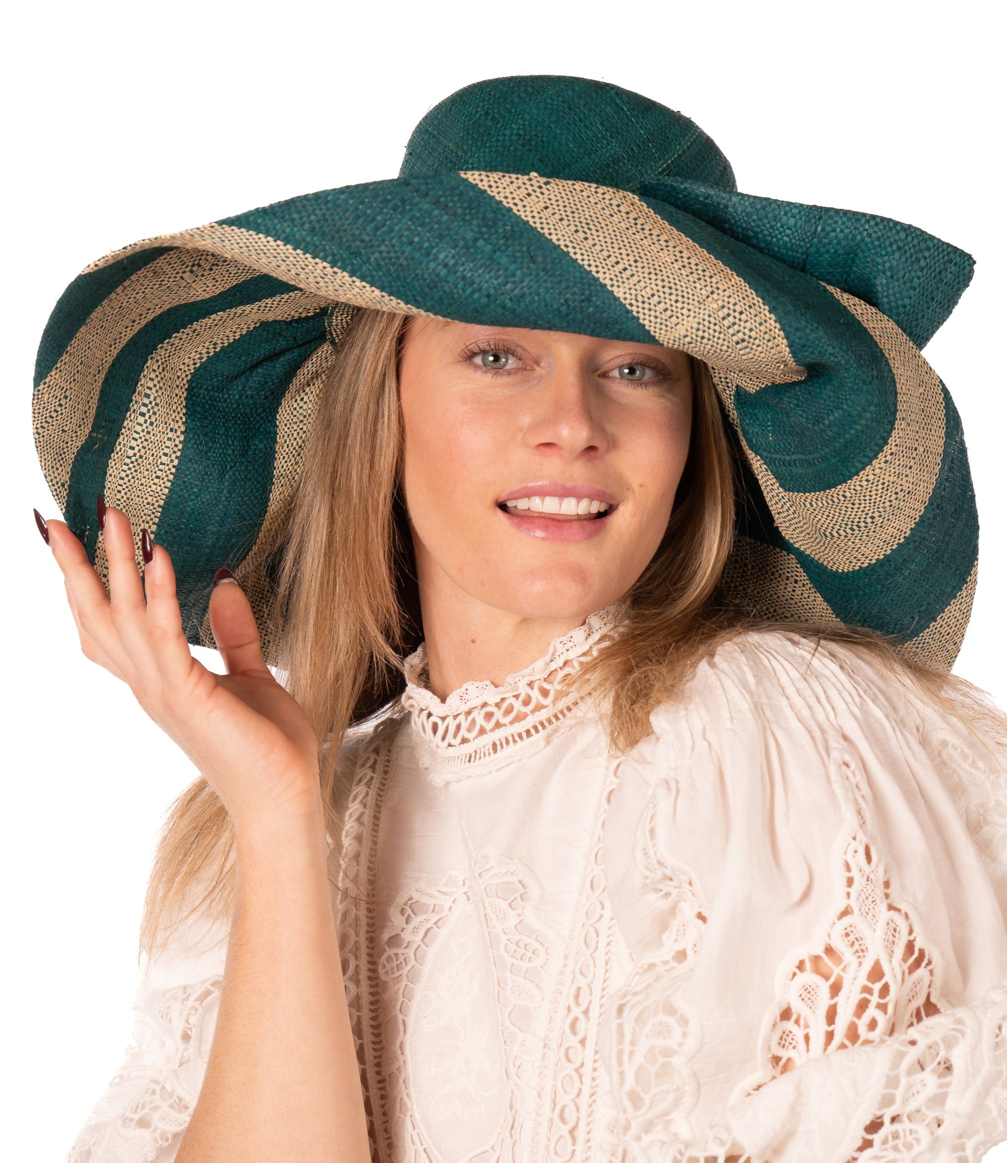 Model wearing Audrey 7" Wide Brim Teal Two Tone Wide Stripe Straw Sun Hats with Big Bow handmade loomed raffia palm fiber in a solid hue of Teal dark/blue/green on the crown and matching oversized big bow embellishment hat band, with two tone even width wide stripe pattern of teal and natural straw color that creates a swirl patterned brim - Shebobo