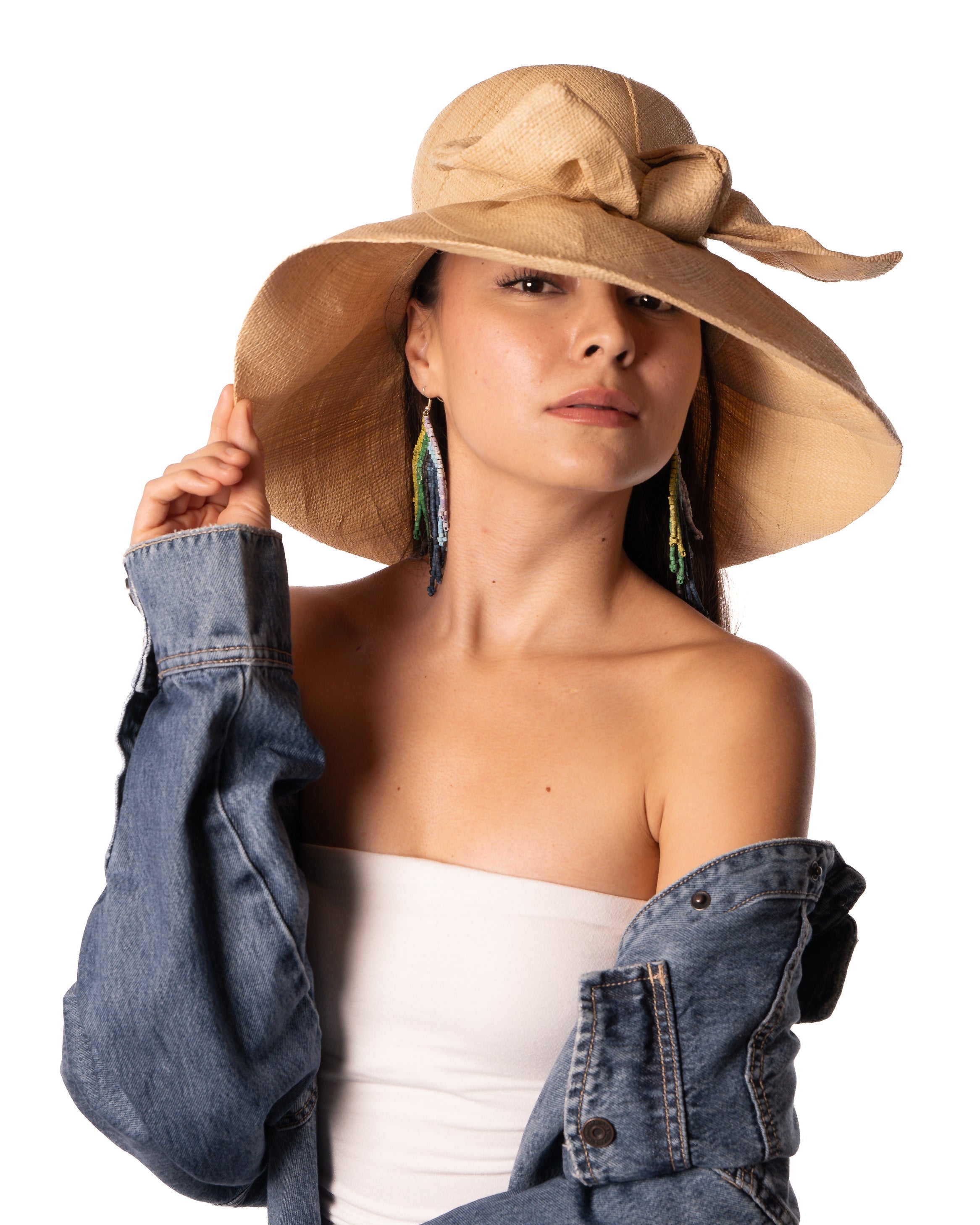 Model wearing Audrey 5" Wide Brim Solid Color Straw Sun Hats with Big Bow handmade loomed natural raffia straw fiber in a solid hue of natural straw color with matching oversized big bow embellishment hat band - Shebobo