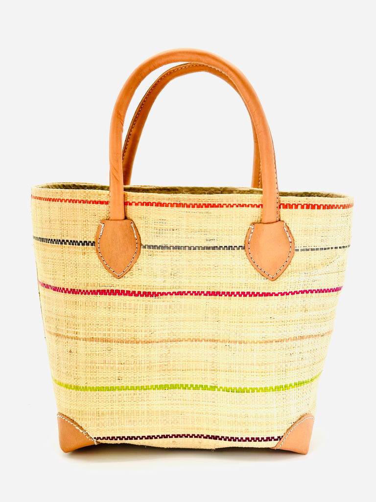 Augustine pinstripes straw basket bag handmade loomed raffia in natural wide horizontal bands with multicolor bright colors of coral red/orange, bordeaux dark red, lime, grey, and fuchsia pink small bands running through in a stripe pattern with leather accents and handles handbag purse - Shebobo
