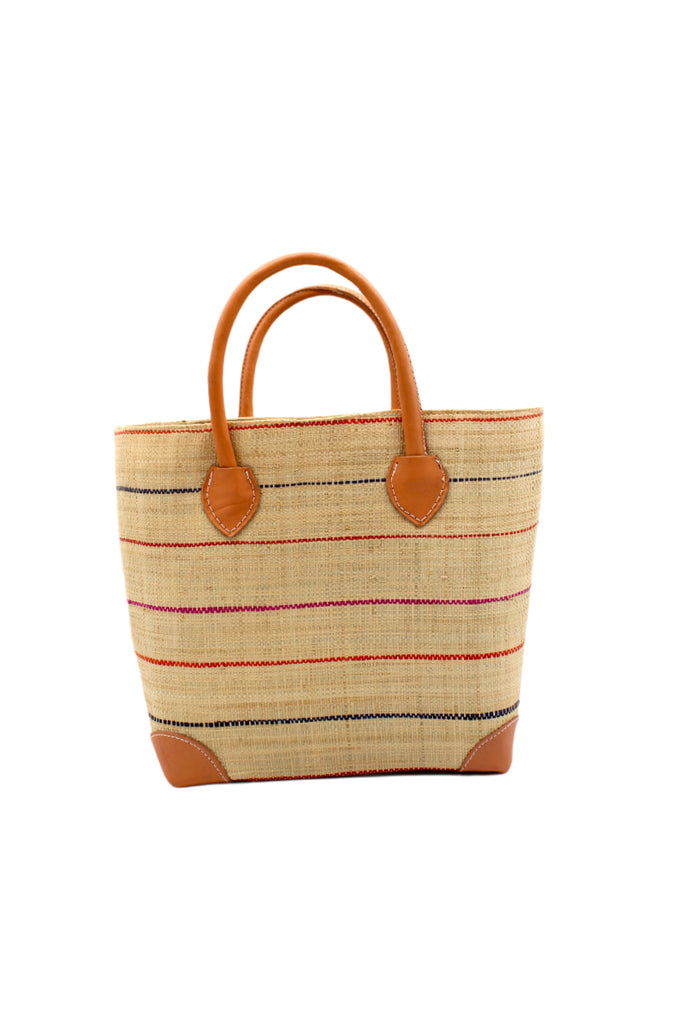 Augustine pinstripes straw basket bag handmade loomed raffia in natural wide horizontal bands with multicolor coral red/orange, fuchsia pink, and navy blue small bands running through in a stripe pattern with leather accents and handles handbag purse - Shebobo