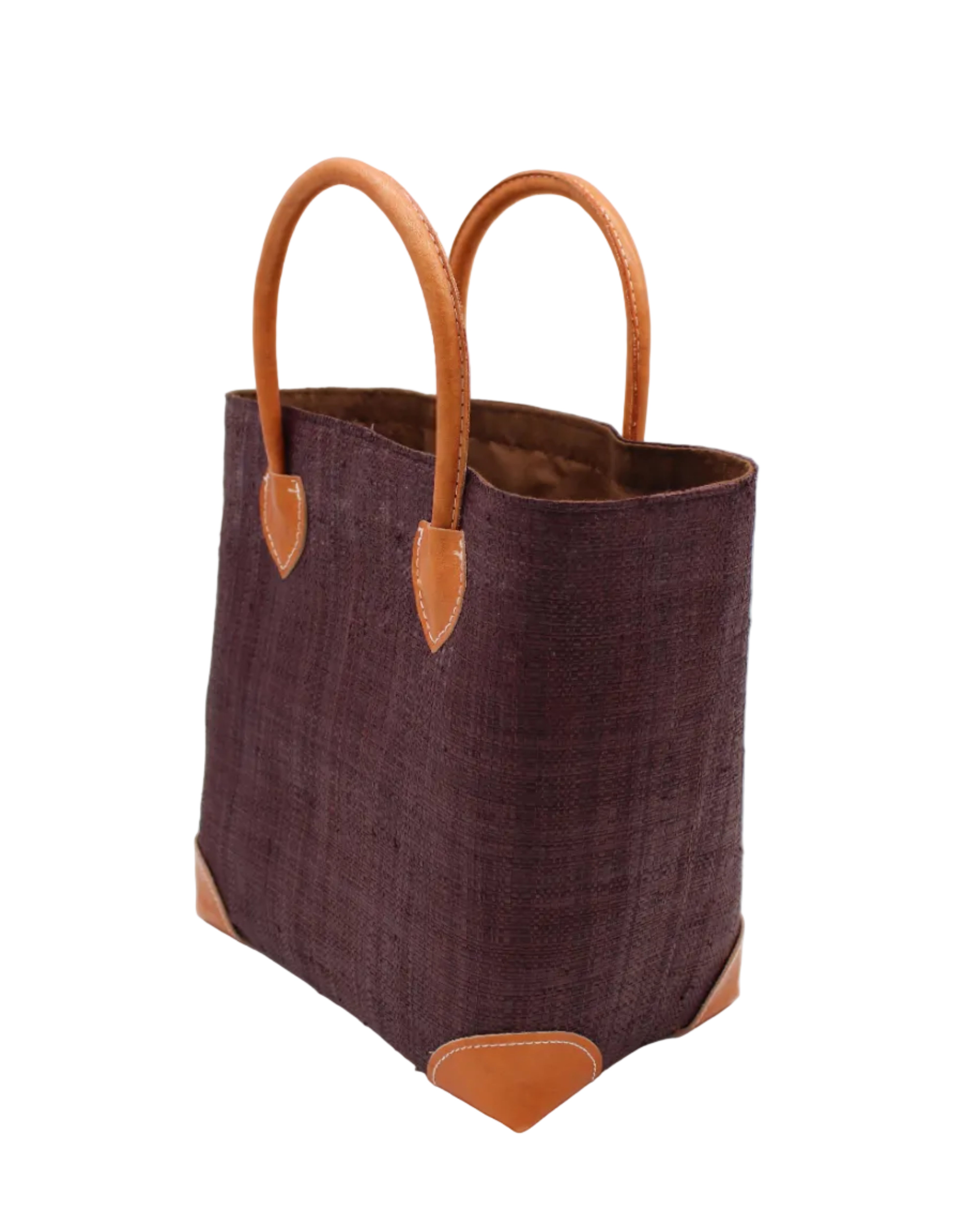 Side view Augustine Straw Basket Bag Mocha handmade loomed raffia palm fiber in a solid hue of mocha chocolate/dark/brown handbag purse with leather accents and handles beach bag - Shebobo