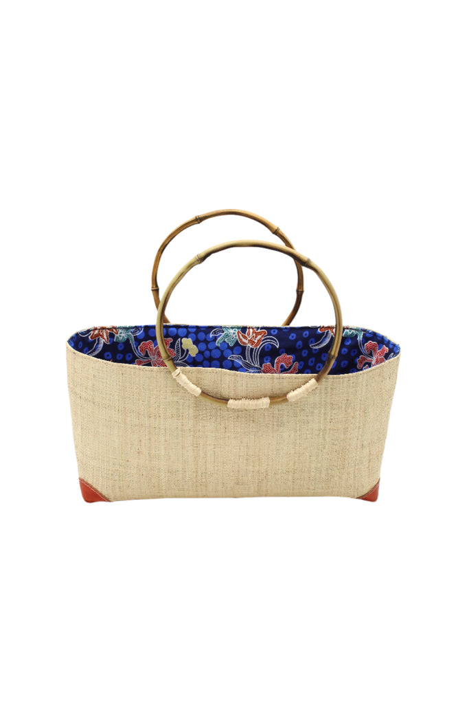 Bebe Straw Handbag with Bamboo Handle handmade loomed natural raffia palm fiber in a solid hue of natural straw color with molded circular bamboo handles, leather feet, and assorted print African wax-cloth fabric liner - Shebobo