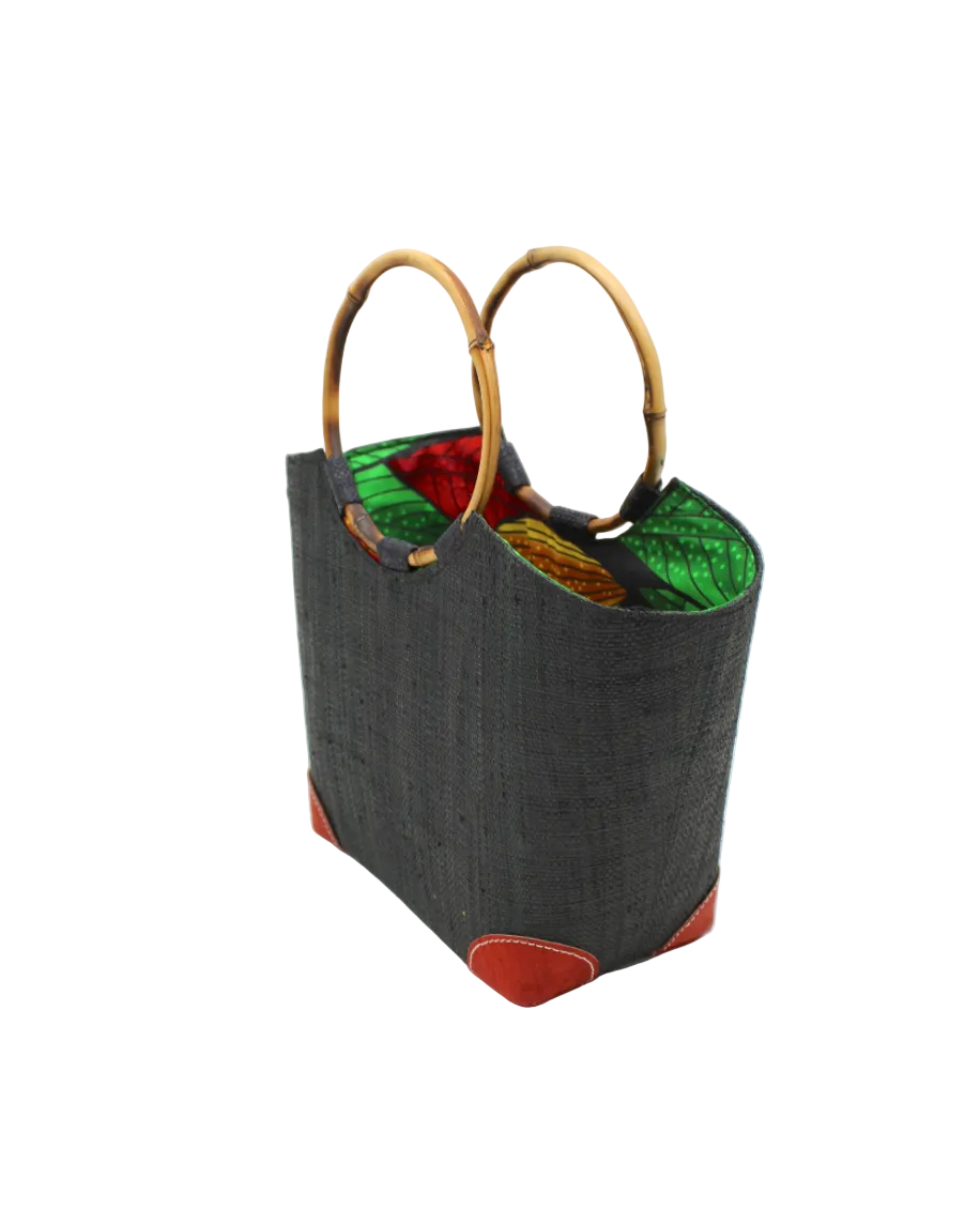 Side view Betty Straw Bucket Bag with Bamboo Handles handmade loomed natural raffia palm fiber in a solid hue of black with circular bamboo handles, leather feet, and colorful African Print wax cloth liner handbag purse tote - Shebobo