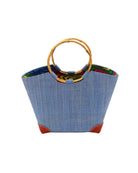 Betty Straw Bucket Bag with Bamboo Handles handmade loomed natural raffia palm fiber in a solid hue of denim light/retro/blue with circular bamboo handles, leather feet, and colorful African Print wax cloth liner handbag purse tote - Shebobo