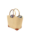 Side view Betty Straw Bucket Bag with Bamboo Handles handmade loomed natural raffia palm fiber in a solid hue of natural straw color with circular bamboo handles, leather feet, and colorful African Print wax cloth liner handbag purse tote - Shebobo