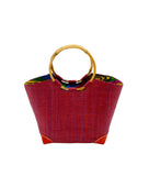 Betty Straw Bucket Bag with Bamboo Handles handmade loomed natural raffia palm fiber in a solid hue of umberwine burgundy/dark/purple/red with circular bamboo handles, leather feet, and colorful African Print wax cloth liner handbag purse tote - Shebobo