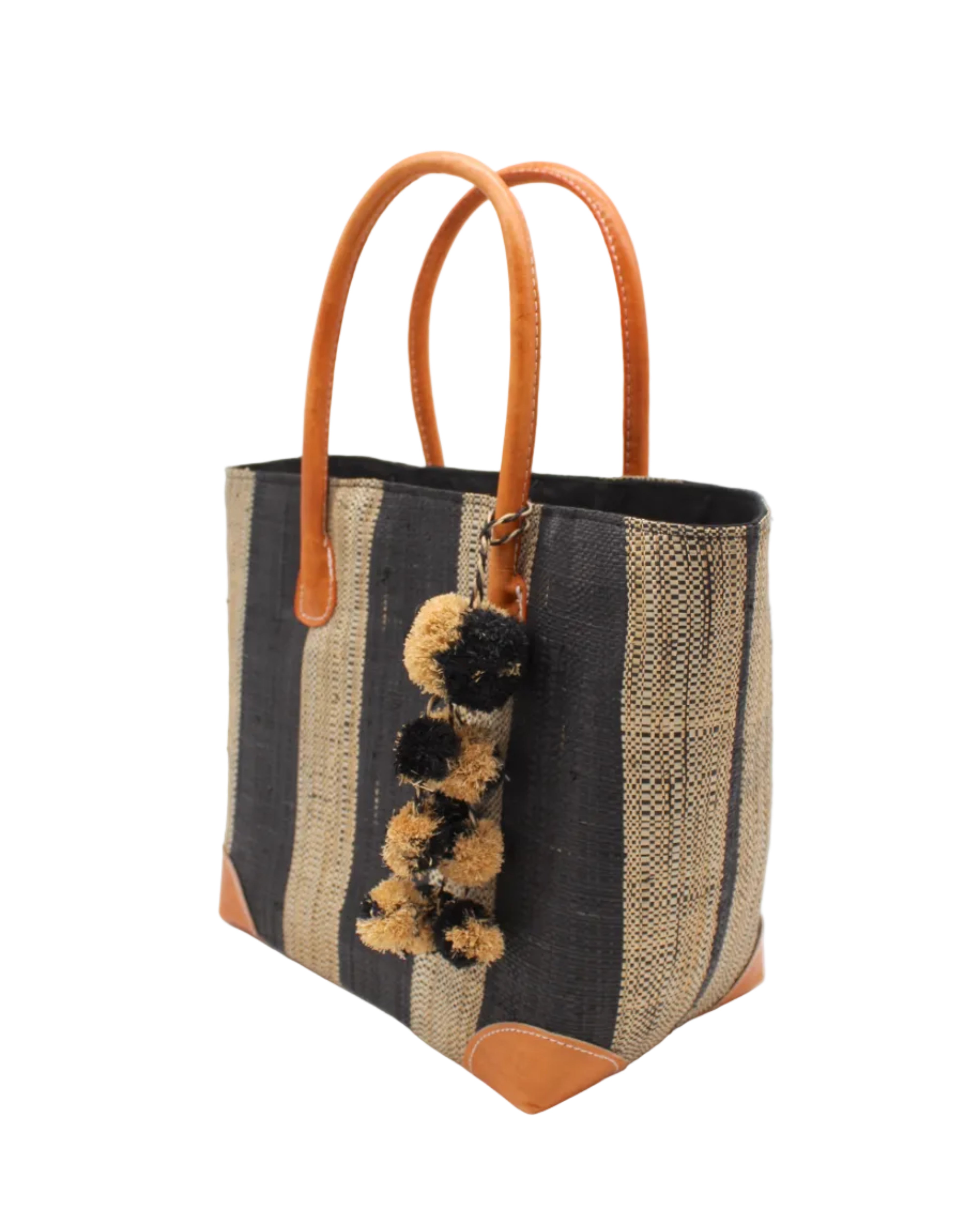 Side view Bora Bora Black Two Tone Stripes Straw Basket Bag with Waterfall Pompoms Charm Embellishment handmade loomed natural raffia palm fiber in a multicolor horizontal stripe pattern of even width wide bands of black and natural straw color with leather handles and feet plus matching waterfall pompom charm embellishment handbag beach bag - Shebobo