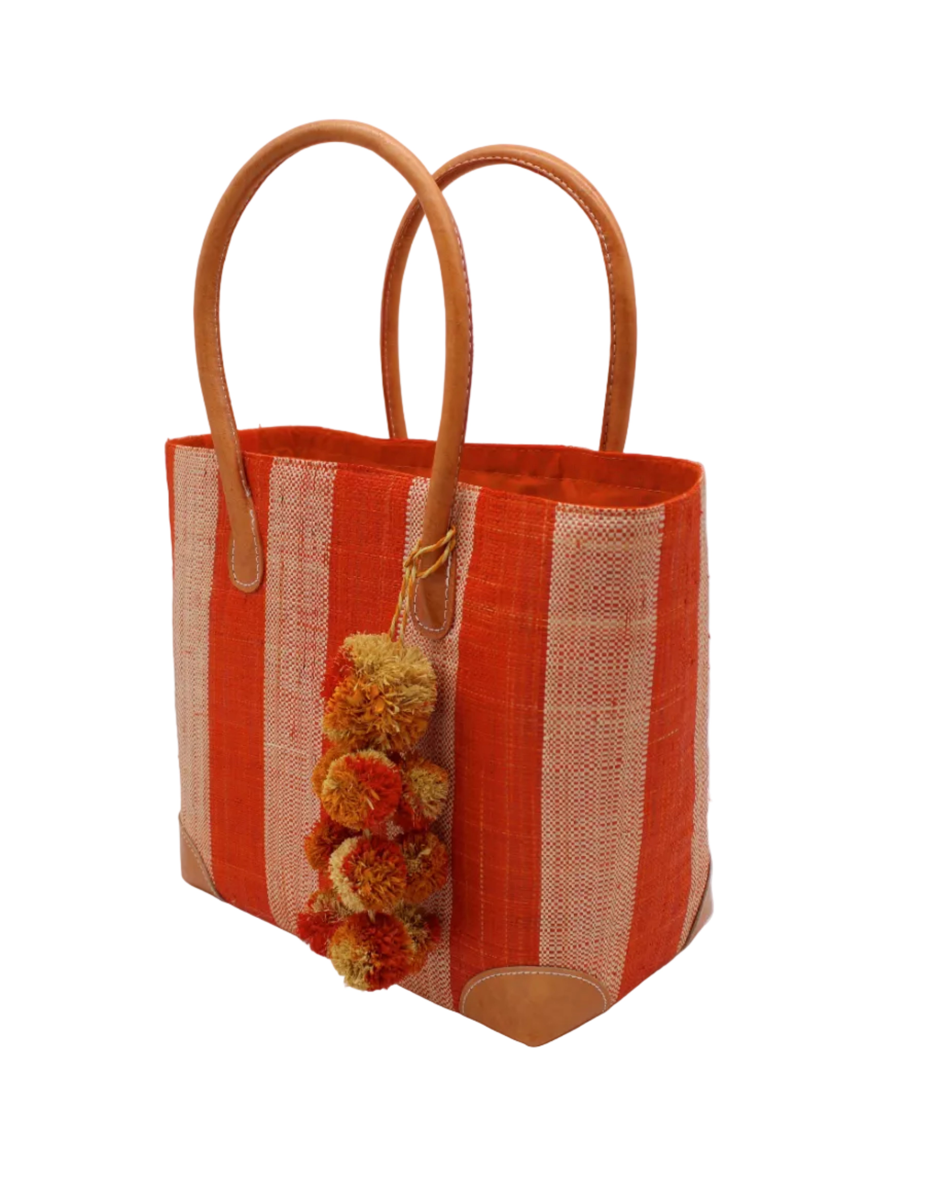 Side view Bora Bora Coral Two Tone Stripes Straw Basket Bag with Waterfall Pompoms Charm Embellishment handmade loomed natural raffia palm fiber in a multicolor horizontal stripe pattern of even width wide bands of coral orange/red and natural straw color with leather handles and feet plus matching waterfall pompom charm embellishment handbag beach bag - Shebobo