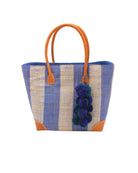 Bora Bora Denim Two Tone Stripes Straw Basket Bag with Waterfall Pompoms Charm Embellishment handmade loomed natural raffia palm fiber in a multicolor horizontal stripe pattern of even width wide bands of denim retro/light/blue and natural straw color with leather handles and feet plus matching waterfall pompom charm embellishment handbag beach bag - Shebobo