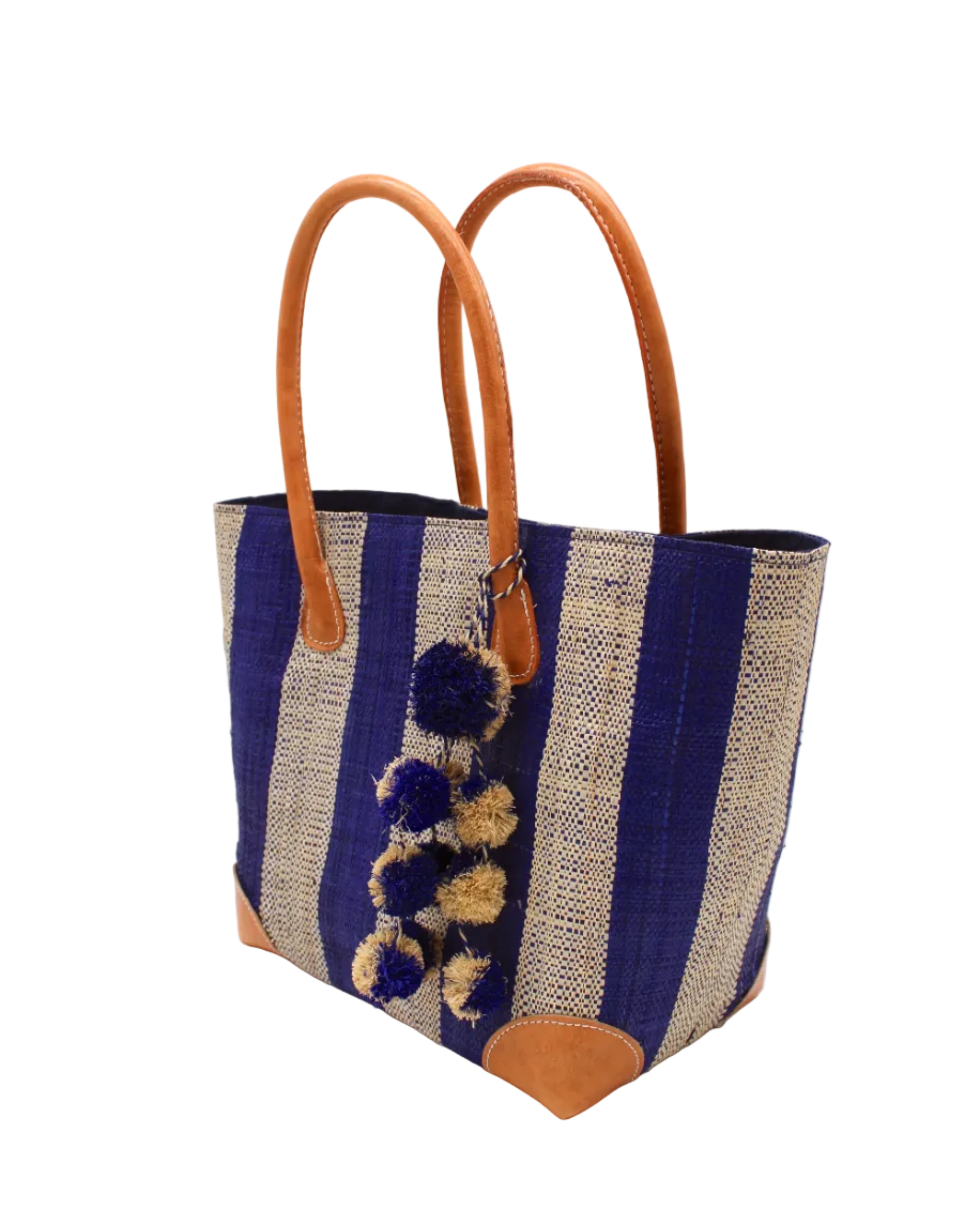 Side view Bora Bora Dusk Two Tone Stripes Straw Basket Bag with Waterfall Pompoms Charm Embellishment handmade loomed natural raffia palm fiber in a multicolor horizontal stripe pattern of even width wide bands of dusk navy/dark/blue and natural straw color with leather handles and feet plus matching waterfall pompom charm embellishment handbag beach bag - Shebobo