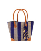 Bora Bora Dusk Two Tone Stripes Straw Basket Bag with Waterfall Pompoms Charm Embellishment handmade loomed natural raffia palm fiber in a multicolor horizontal stripe pattern of even width wide bands of dusk navy/dark/blue and natural straw color with leather handles and feet plus matching waterfall pompom charm embellishment handbag beach bag - Shebobo
