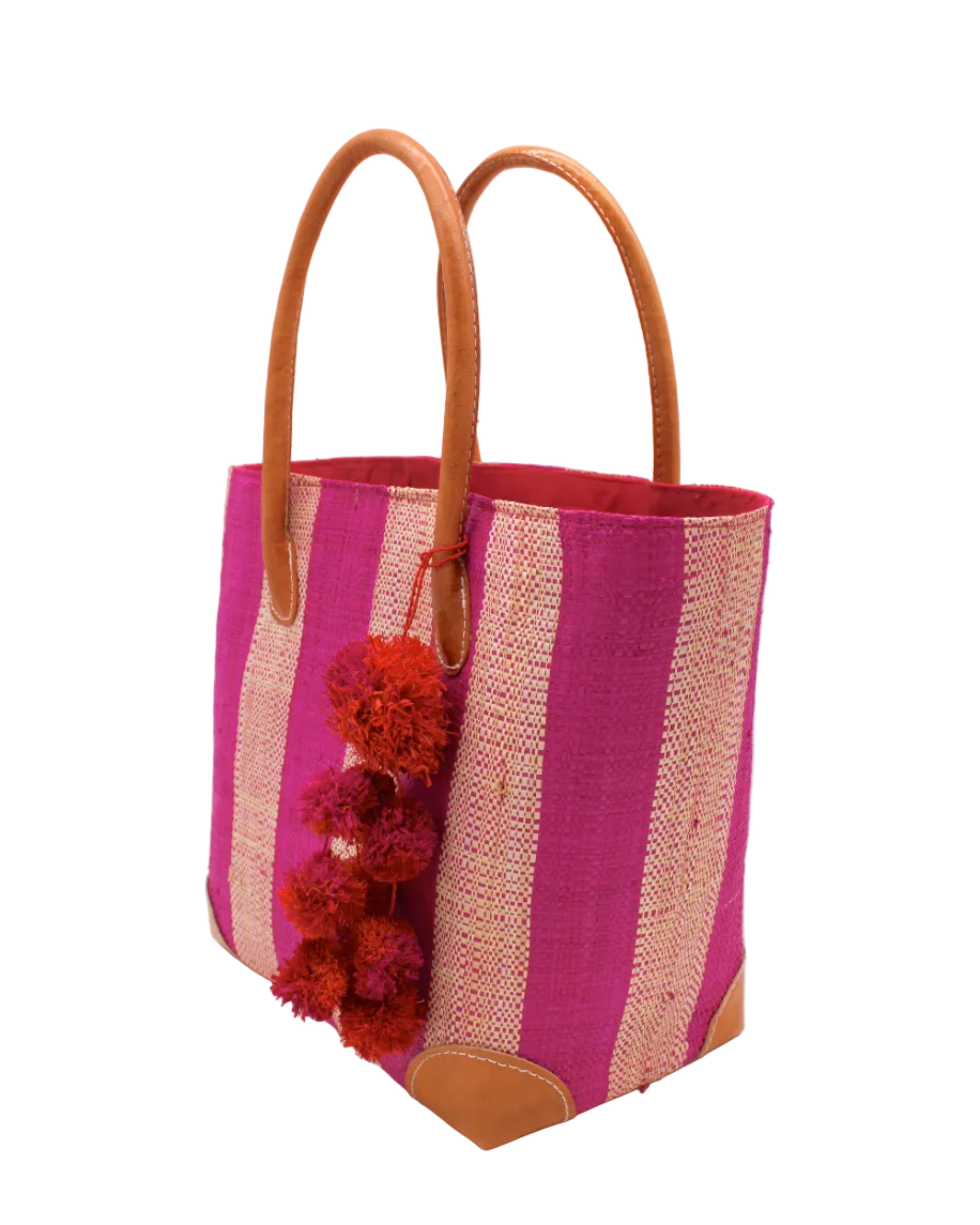 Side view Bora Bora Fuchsia Two Tone Stripes Straw Basket Bag with Waterfall Pompoms Charm Embellishment handmade loomed natural raffia palm fiber in a multicolor horizontal stripe pattern of even width wide bands of fuchsia hot/bright/barbie/pink and natural straw color with leather handles and feet plus matching waterfall pompom charm embellishment handbag beach bag - Shebobo