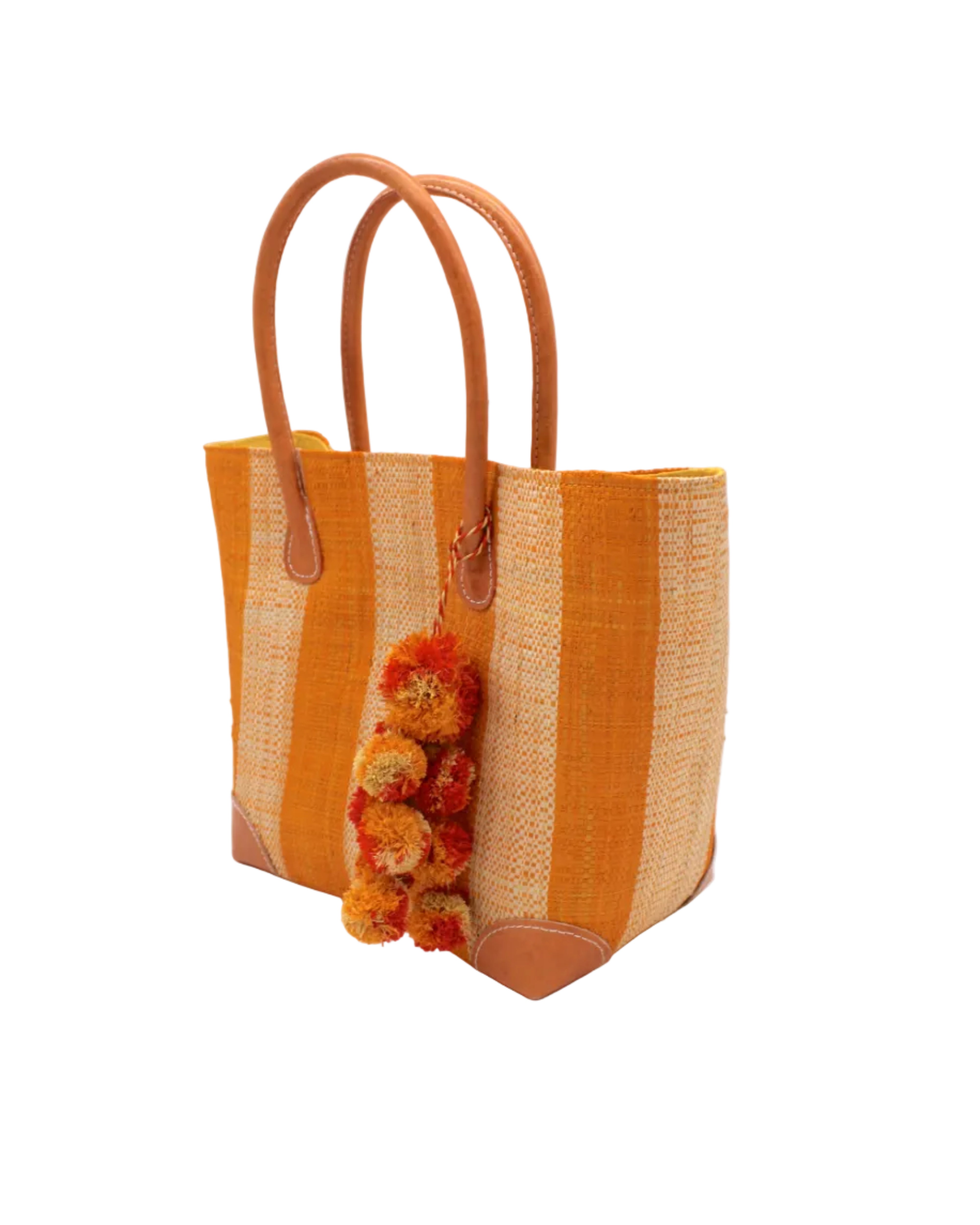Side view Bora Bora Saffron Two Tone Stripes Straw Basket Bag with Waterfall Pompoms Charm Embellishment handmade loomed natural raffia palm fiber in a multicolor horizontal stripe pattern of even width wide bands of saffron orange/yellow and natural straw color with leather handles and feet plus matching waterfall pompom charm embellishment handbag beach bag - Shebobo