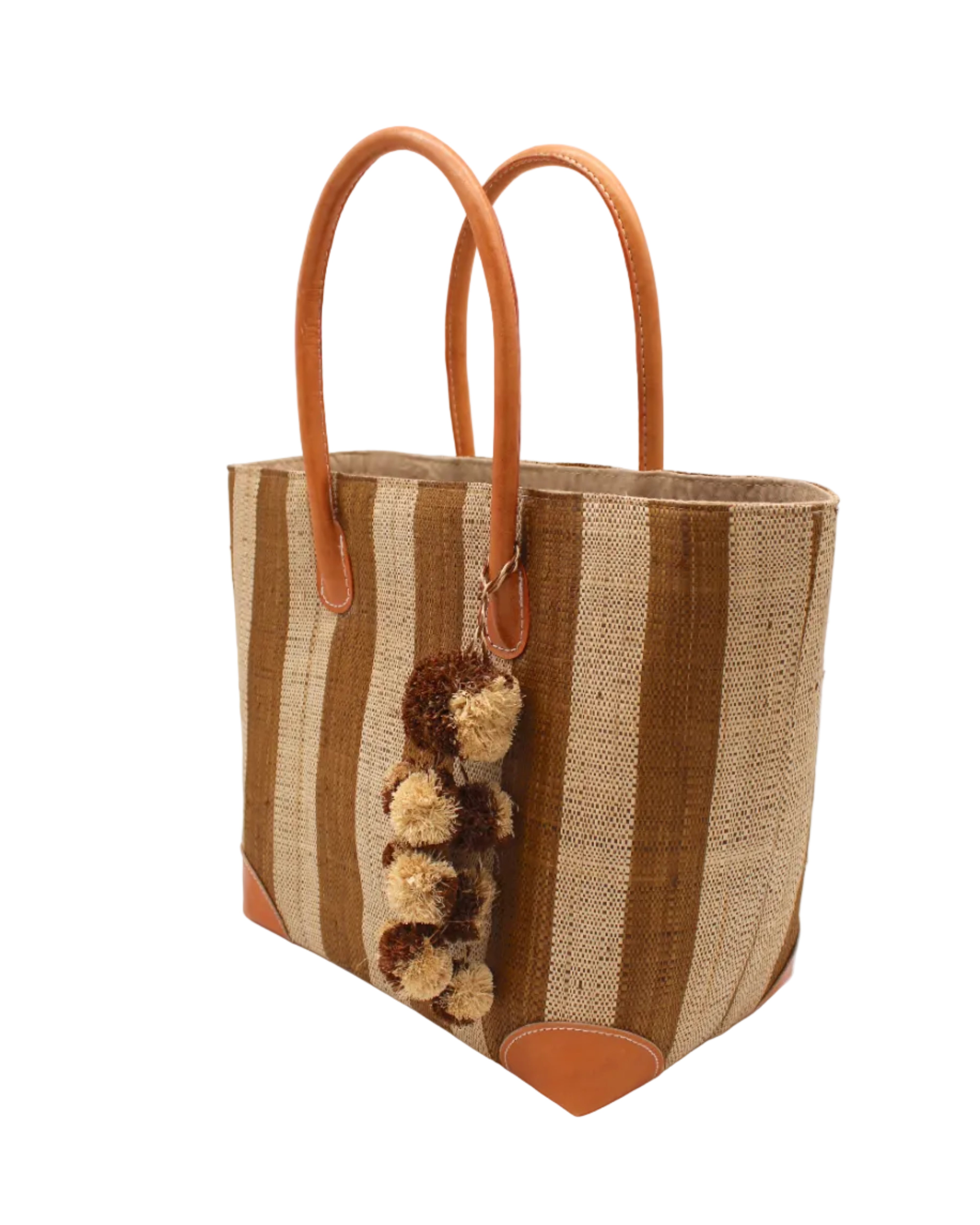 Side view Bora Bora Tobacco Two Tone Stripes Straw Basket Bag with Waterfall Pompoms Charm Embellishment handmade loomed natural raffia palm fiber in a multicolor horizontal stripe pattern of even width wide bands of tobacco cinnamon/dark/brown and natural straw color with leather handles and feet plus matching waterfall pompom charm embellishment handbag beach bag - Shebobo