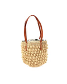 Boucle Natural Crochet Small Straw Handbag  handmade woven raffia palm fiber in a solid hue of natural straw color in a supple nub/ball texture of horizontal bands around the bag with link weave around the top plus assorted print drawstring liner and leather handles  shoulder bag purse - Shebobo