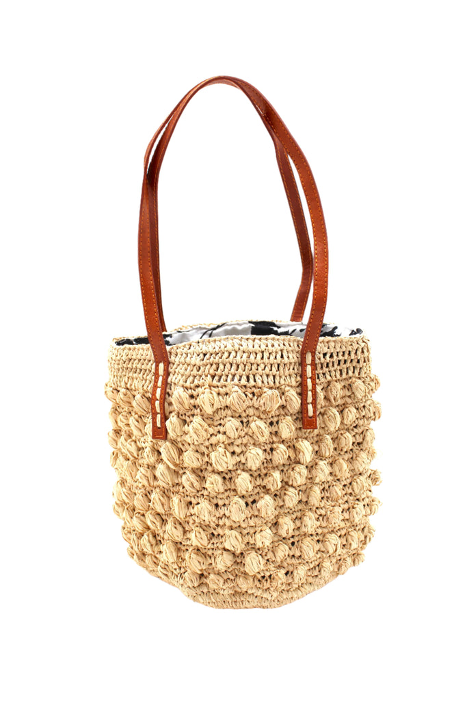 Boucle Natural Crochet Small Straw Handbag  handmade woven raffia palm fiber in a solid hue of natural straw color in a supple nub/ball texture of horizontal bands around the bag with link weave around the top plus assorted print drawstring liner and leather handles  shoulder bag purse - Shebobo