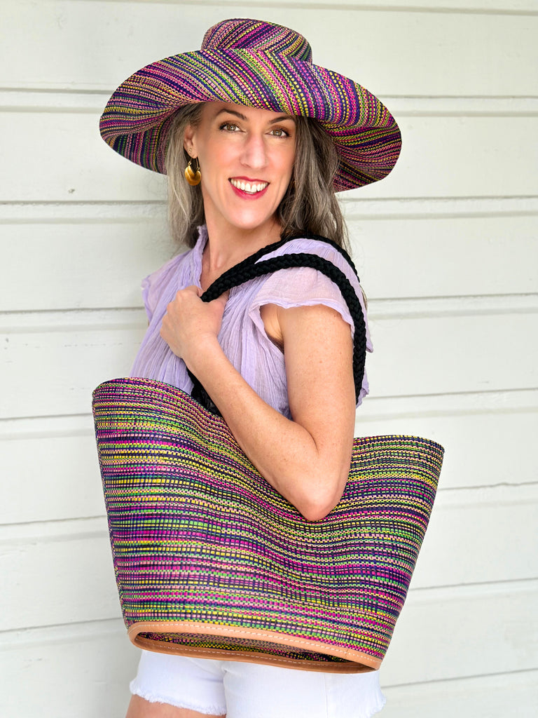 Model wearing 5" & 7" Wide Brim Orchid Multi Melange Packable Straw Sun Hat multicolor heather pattern of orchid purple, fuchsia pink, navy blue, green, yellow, pink, black, etc. with matching Brighton Multi Melange Straw Beach Tote Bag with Rope Handle Handbag Beach Bag Tote - Shebobo