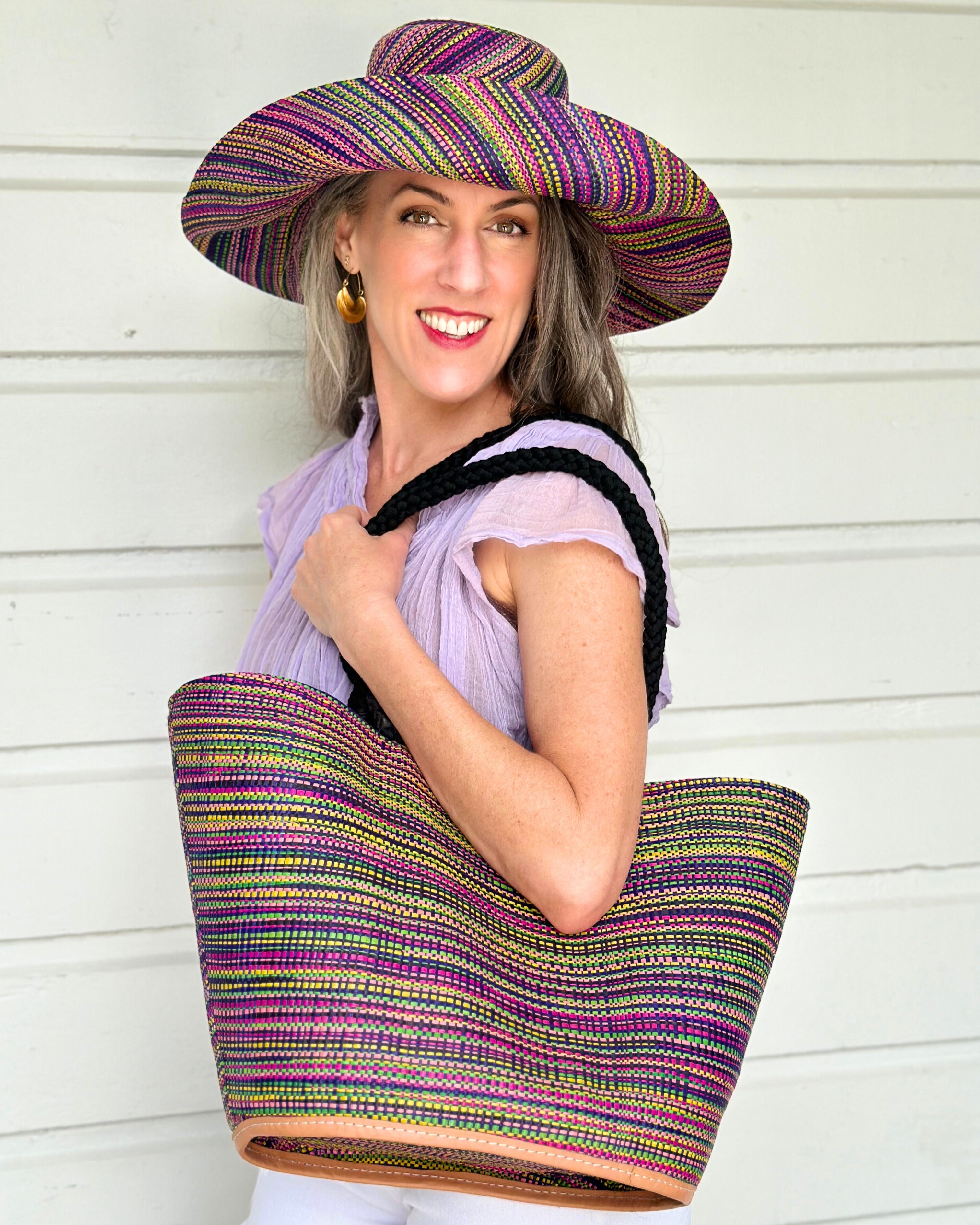 Model wearing Monica 5" & 7" Wide Brim Orchid Multi Melange Packable Straw Sun Hat multicolor heather pattern of orchid purple, fuchsia pink, navy blue, green, yellow, pink, black, etc. with matching Brighton Multi Melange Straw Beach Tote Bag with Rope Handle Handbag Beach Bag Tote - Shebobo