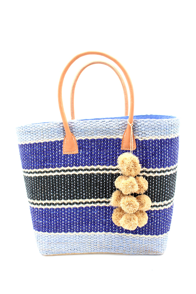 Cabrillo Blue Multi Sisal Basket Bag with Waterfall Pompoms Charm Embellishment handmade woven natural sisal fiber in multiple horizontal width stripes of light/baby/blue, navy/dark/blue, black, and natural straw color in a stripe pattern handbag with leather handles - Shebobo'