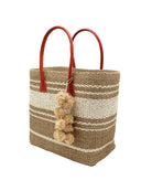 Side view Cabrillo Sisal Basket Bag with Waterfall Pompoms Charm Embellishment handmade natural sisal fiber woven into a multicolor two tone Cappuccino tea/light/brown and natural straw color  horizontal stripe pattern with muti-width bands of color plus leather handles and natural raffia charm shoulder bag beach bag - Shebobo