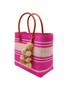 Side view Cabrillo Sisal Basket Bag with Waterfall Pompoms Charm Embellishment handmade natural sisal fiber woven into a multicolor two tone Fuchsia hot/bright/barbie/pink and natural straw color  horizontal stripe pattern with muti-width bands of color plus leather handles and natural raffia charm shoulder bag beach bag - Shebobo