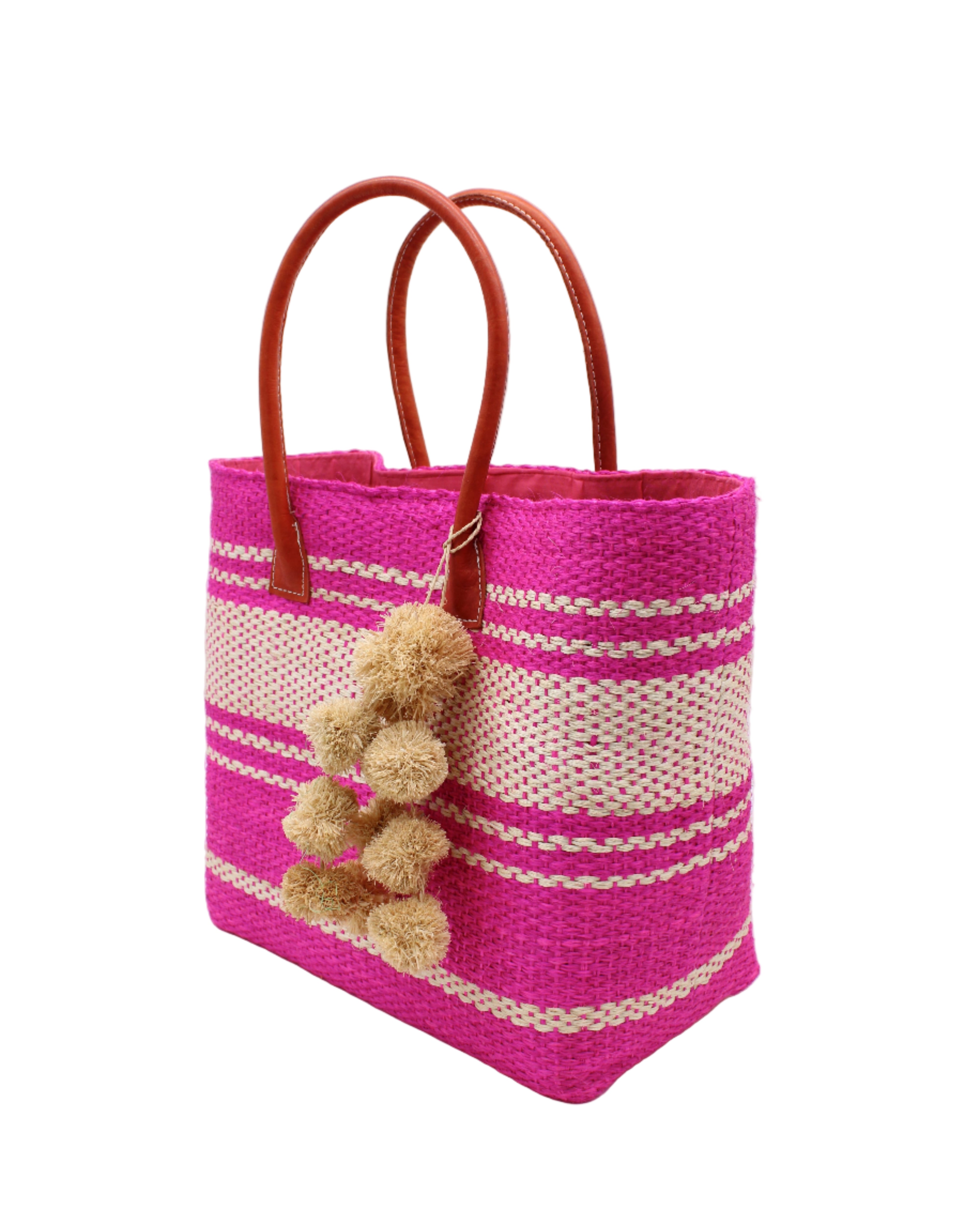 Side view Cabrillo Sisal Basket Bag with Waterfall Pompoms Charm Embellishment handmade natural sisal fiber woven into a multicolor two tone Fuchsia hot/bright/barbie/pink and natural straw color  horizontal stripe pattern with muti-width bands of color plus leather handles and natural raffia charm shoulder bag beach bag - Shebobo