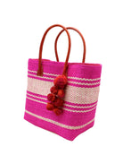 Side view Cabrillo Sisal Basket Bag with Waterfall Pompoms Charm Embellishment handmade natural sisal fiber woven into a multicolor two tone Fuchsia hot/bright/barbie/pink and natural straw color  horizontal stripe pattern with muti-width bands of color plus leather handles and multicolor raffia charm shoulder bag beach bag - Shebobo