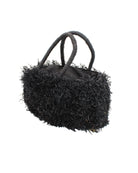 Side view Calypso Pompom Pouf Crochet Straw Basket Handbag handmade natural raffia palm fiber in a solid hue of Black with brushed fringe strands crochet and knotted into a pouf texture with matching wrapped handles purse - Shebobo