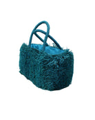 Side view Calypso Pompom Pouf Crochet Straw Basket Handbag handmade natural raffia palm fiber in a solid hue of Turquoise blue/green with brushed fringe strands crochet and knotted into a pouf texture with matching wrapped handles purse - Shebobo