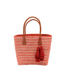 Cancun Small Sisal Basket Bag with Tassel Charm handmade natural sisal fibers woven into even width horizontal bands of coral orange and natural straw color that create a pinstripe pattern with matching knotted raffia tufts tassel charm embellishment and leather handles beach bag - Shebobo