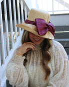 Model wearing Cara Big Bow Straw Hat Handmade loomed raffia straw hat solid natural bucket hat with large umberwine bordeaux/claret/deep/dark/red/purple bow - Shebobo