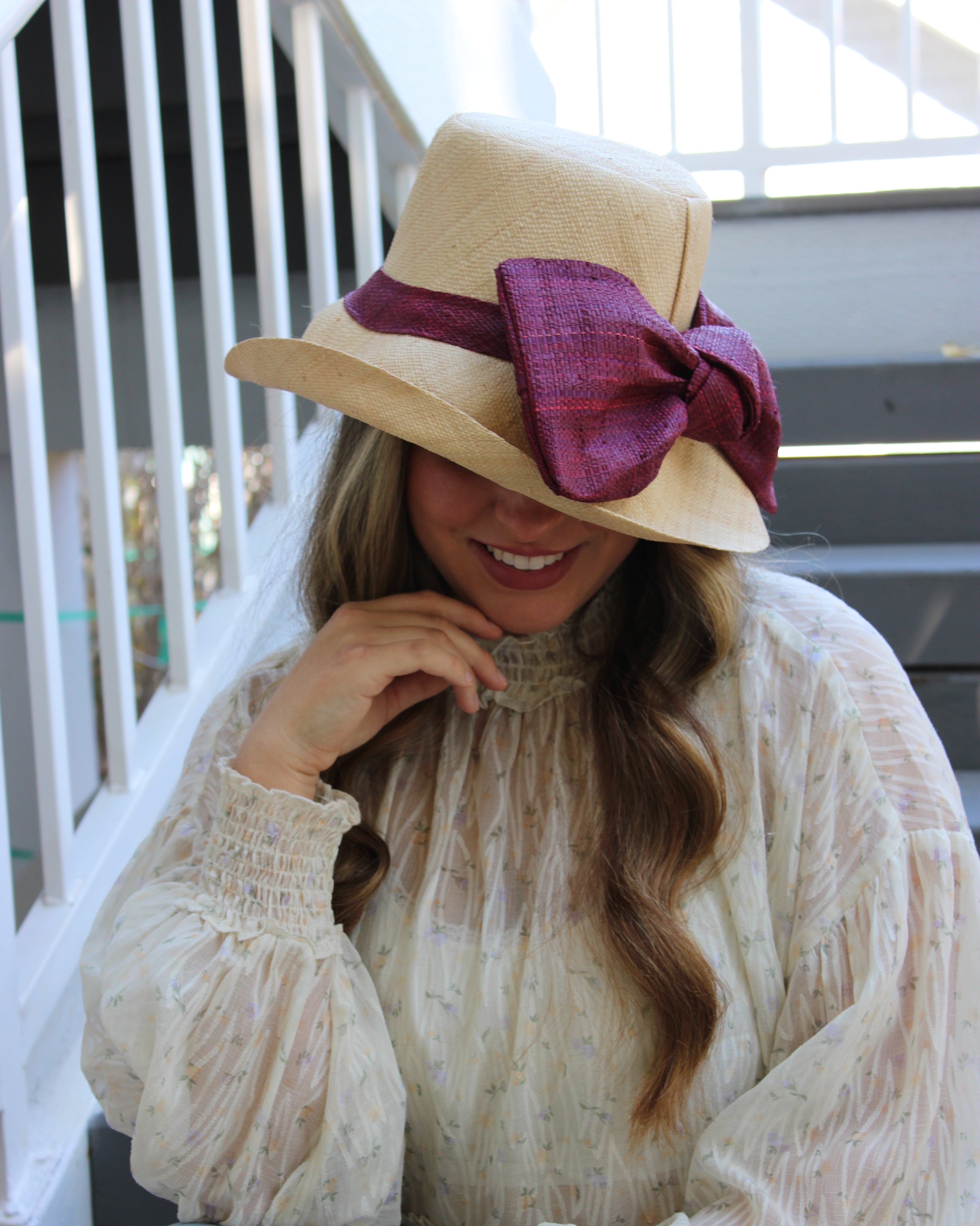 Model wearing Cara Big Bow Straw Hat Handmade loomed raffia straw hat solid natural bucket hat with large umberwine bordeaux/claret/deep/dark/red/purple bow - Shebobo