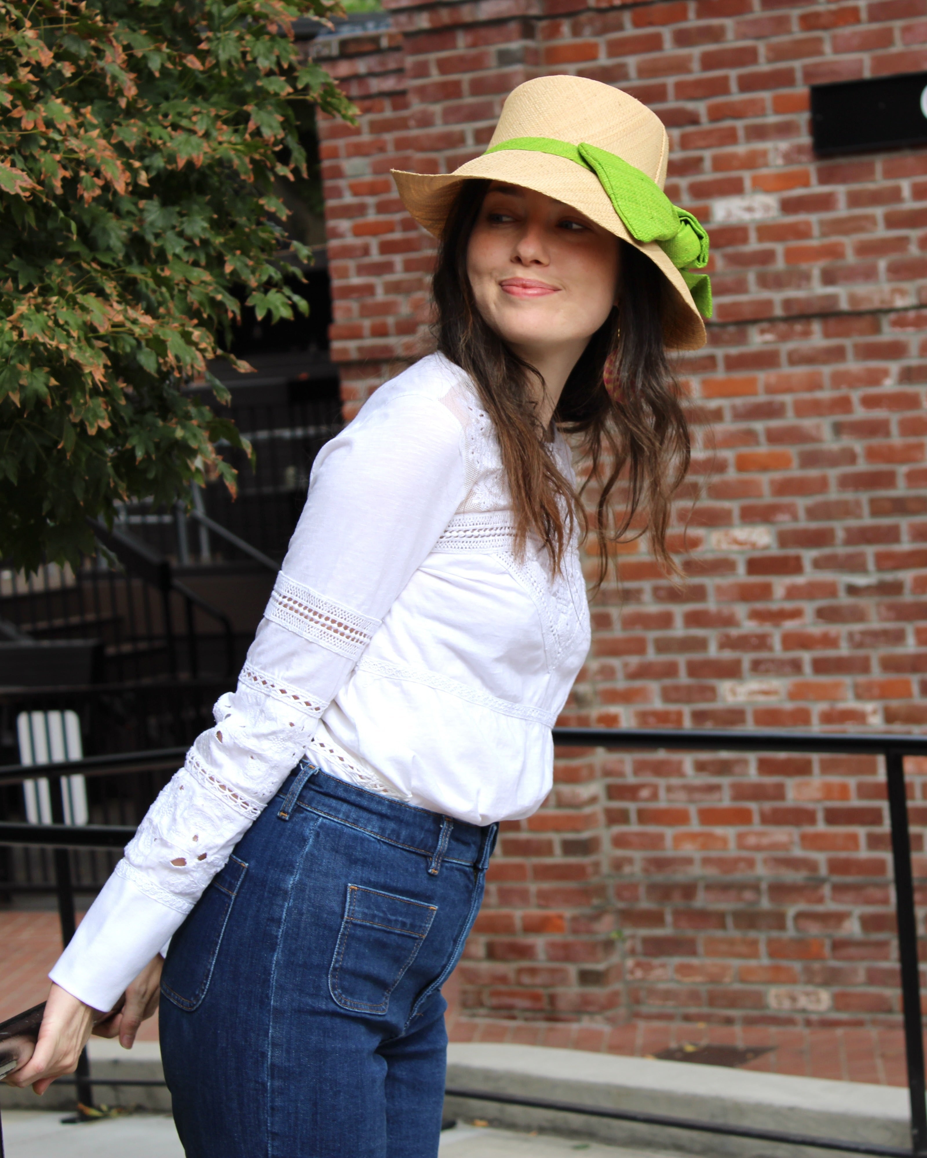 Model wearing Cara Big Bow Straw Hat Handmade loomed raffia straw hat solid natural bucket hat with large midori lime/bright/neon/green bow - Shebobo