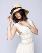 Model wearing Cara Big Bow Straw Hat Handmade loomed raffia straw hat solid natural bucket hat with large black bow - Shebobo