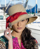 Model wearing Cara Big Bow Straw Hat Handmade loomed raffia straw hat solid natural bucket hat with large red bow - Shebobo