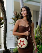 Model wearing Carmel Crochet Round Flower Crossbody bag with Tassel Assorted Flower colors with adjustable leather strap and tassel zipper pull purse - Shebobo