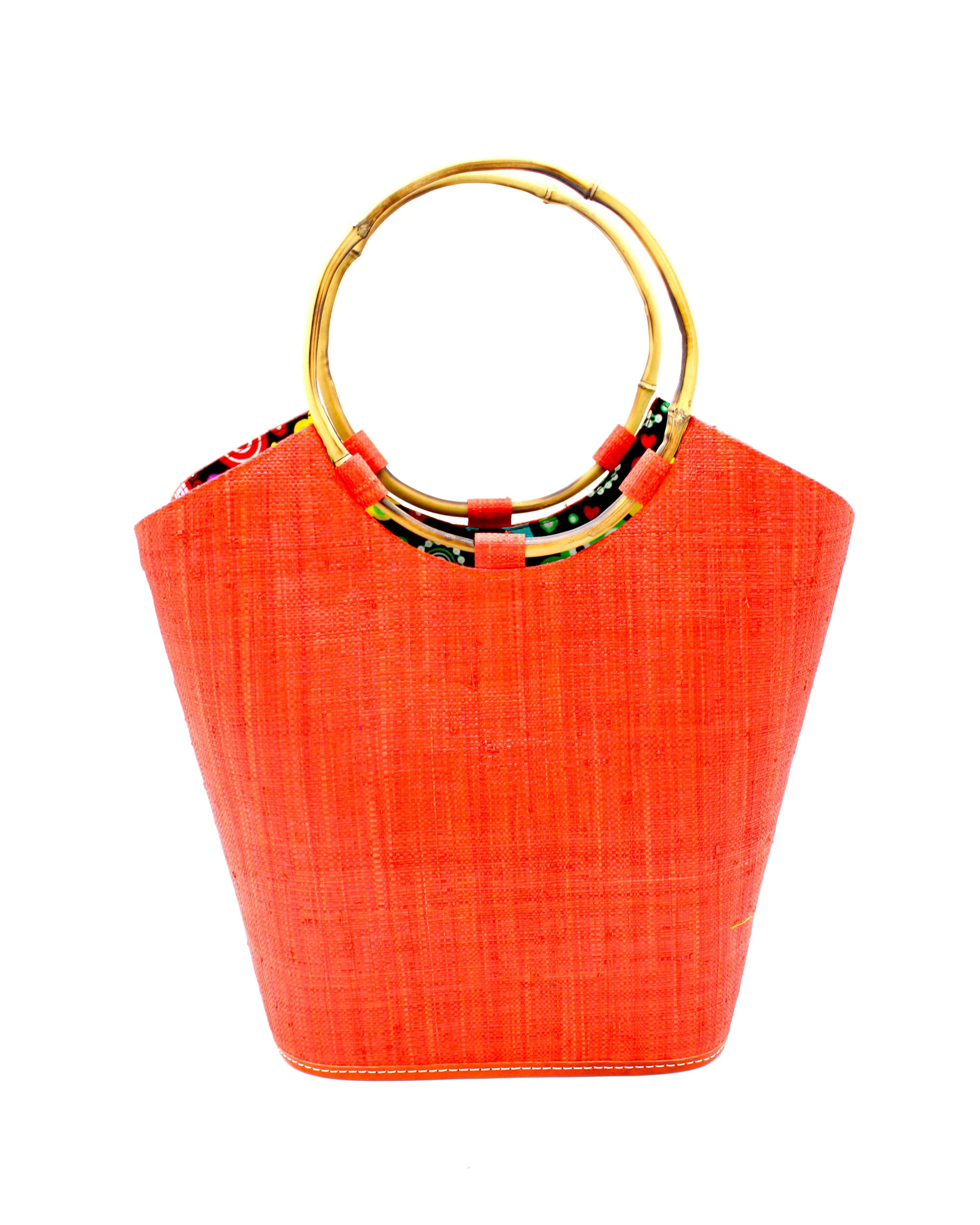 Carmen Coral Straw Bucket Bag with Bamboo Handles handmade loomed raffia in a solid hue of coral orange/red with assorted African print fabric liner handbag - Shebobo