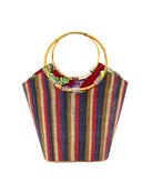 Carmen Solid/Stripes Straw Bucket Bag with Bamboo Handles Dark and Moody multicolor vertical stripe pattern of brown, red, blue, natural, and black with assorted liner purse - Shebobo
