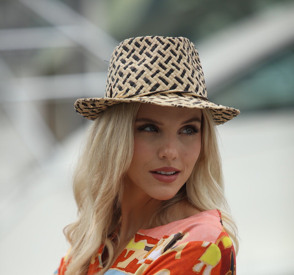 Model wearing Charlie Black - Unisex Fedora Straw Hats handmade woven raffia palm fiber in a two tone crosshatch pattern of black and natural straw color pinched crown structured narrow brim with looped edging and matching raffia twist hat band - Shebobo