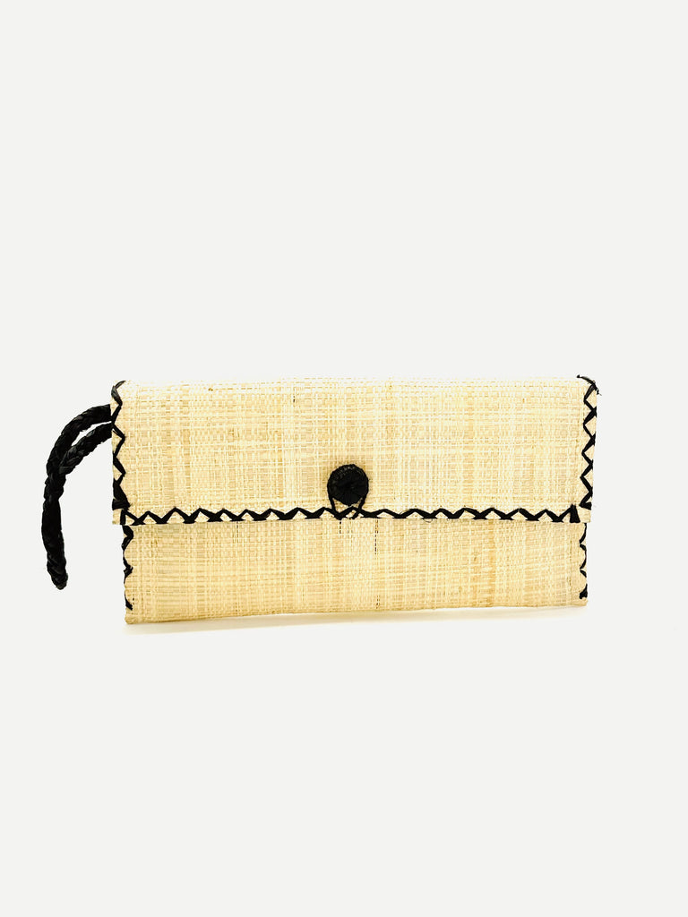 ChiChi Natural Straw Clutch Bag handmade loomed raffia palm fiber wristlet in natural straw color with black cross stitch edging, button & loop closure, and braided wrist strap - Shebobo