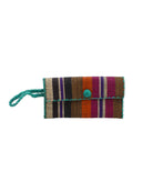 ChiChi Revel Swirl Multicolor Straw Clutch Bag handmade loomed raffia palm fiber wristlet in multi-width bands of teal dark/blue/green, fuchsia hot/bright/barbie/pink, deep purple, black, coral orange/red, cinnamon tobacco/dark/brown, and natural straw color that create a vertical stripe pattern with teal color cross stitch edging, button & loop closure, and braided wrist strap - Shebobo