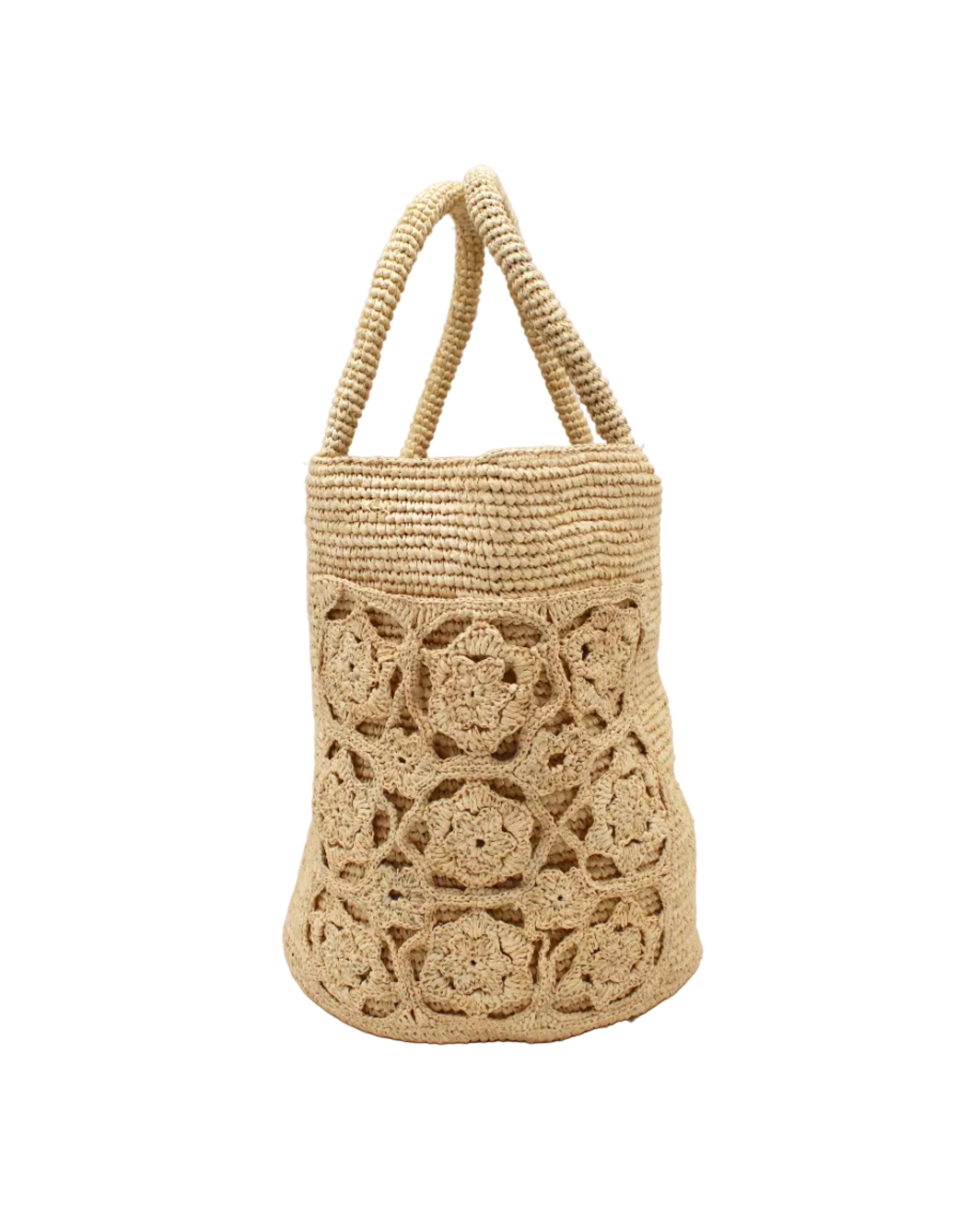 Detail view Colette FlowerCrochet Straw Basket Handbag with Pockets handmade natural raffia palm fiber in a solid hue of natural straw color with geometric granny square floral cutout pattern on two large external pockets tote bag - Shebobo